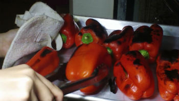 red bell peppers roasting under the broiler